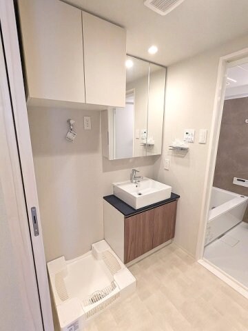 物件内観写真8　(2面鏡付ハンドシャワー付独立洗面台、タオルラックの上にスマホ)